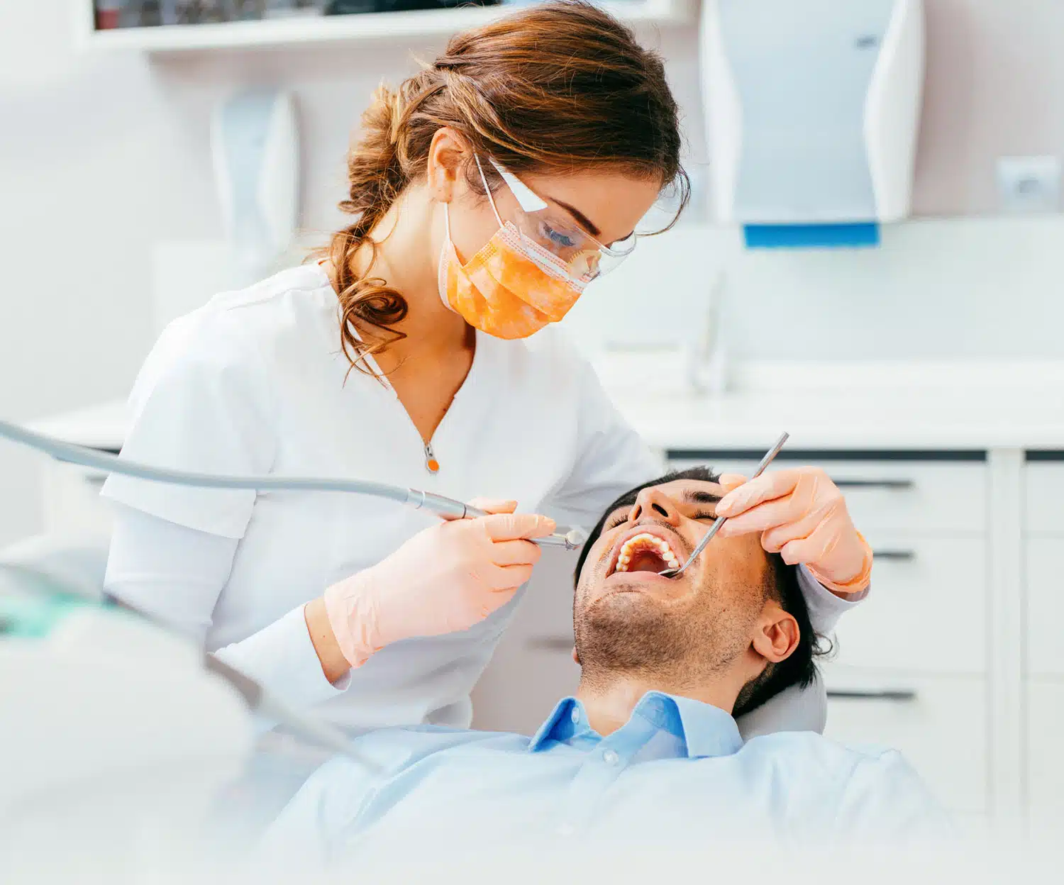 Dentist doing procedure in a male patient