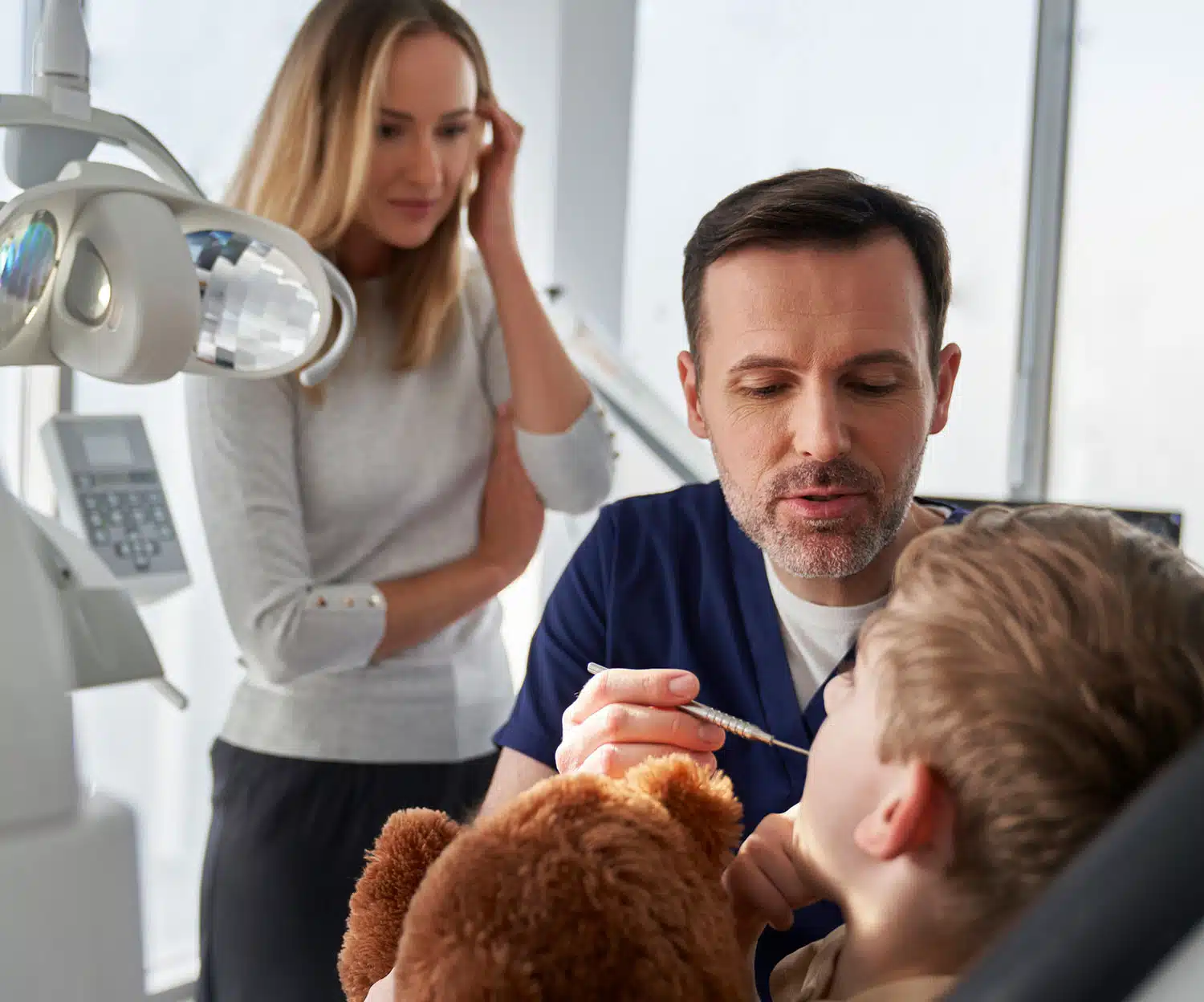 Child sitting in a dental chair receiving care from a pediatric dentist