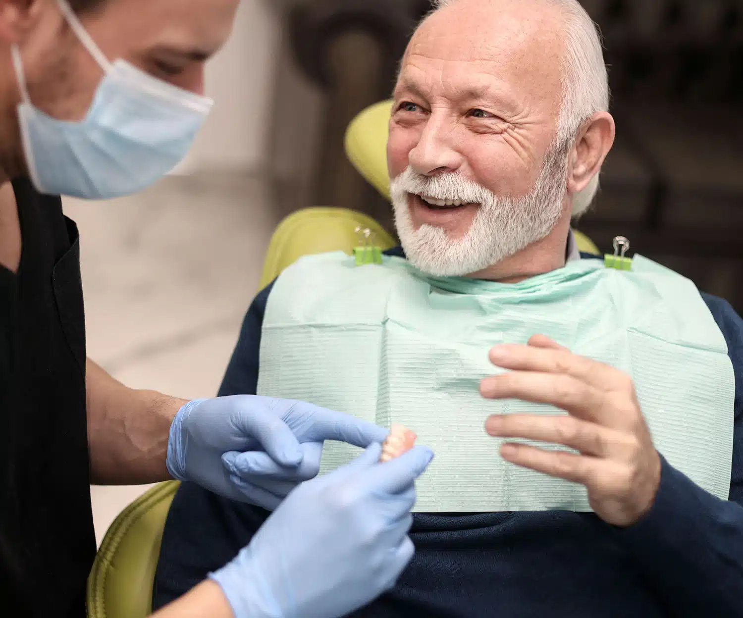 Patient relaxed and smiling during a dental exam with a caring dentist
