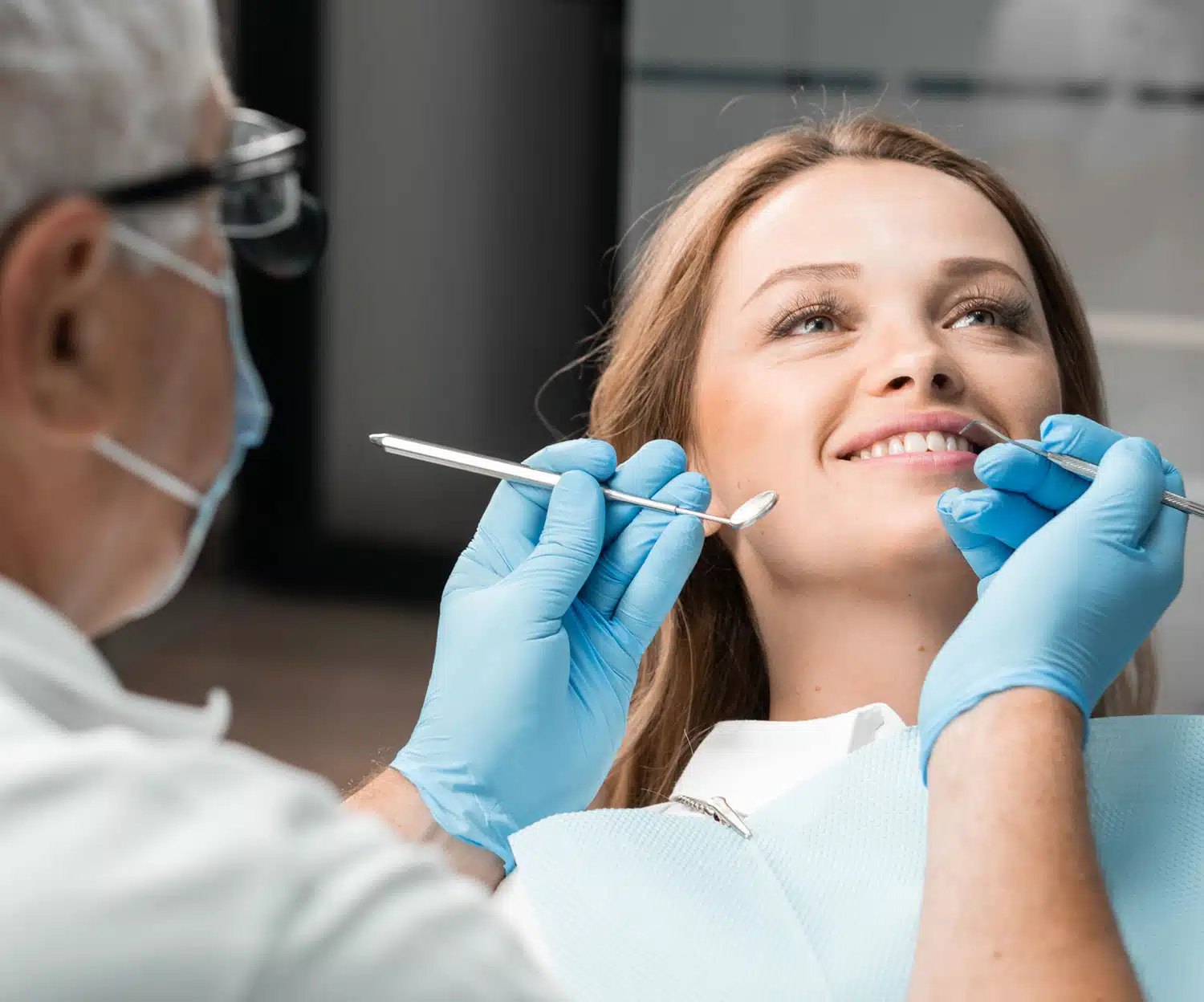 Young woman smiling as the dentist performs a gentle check-up