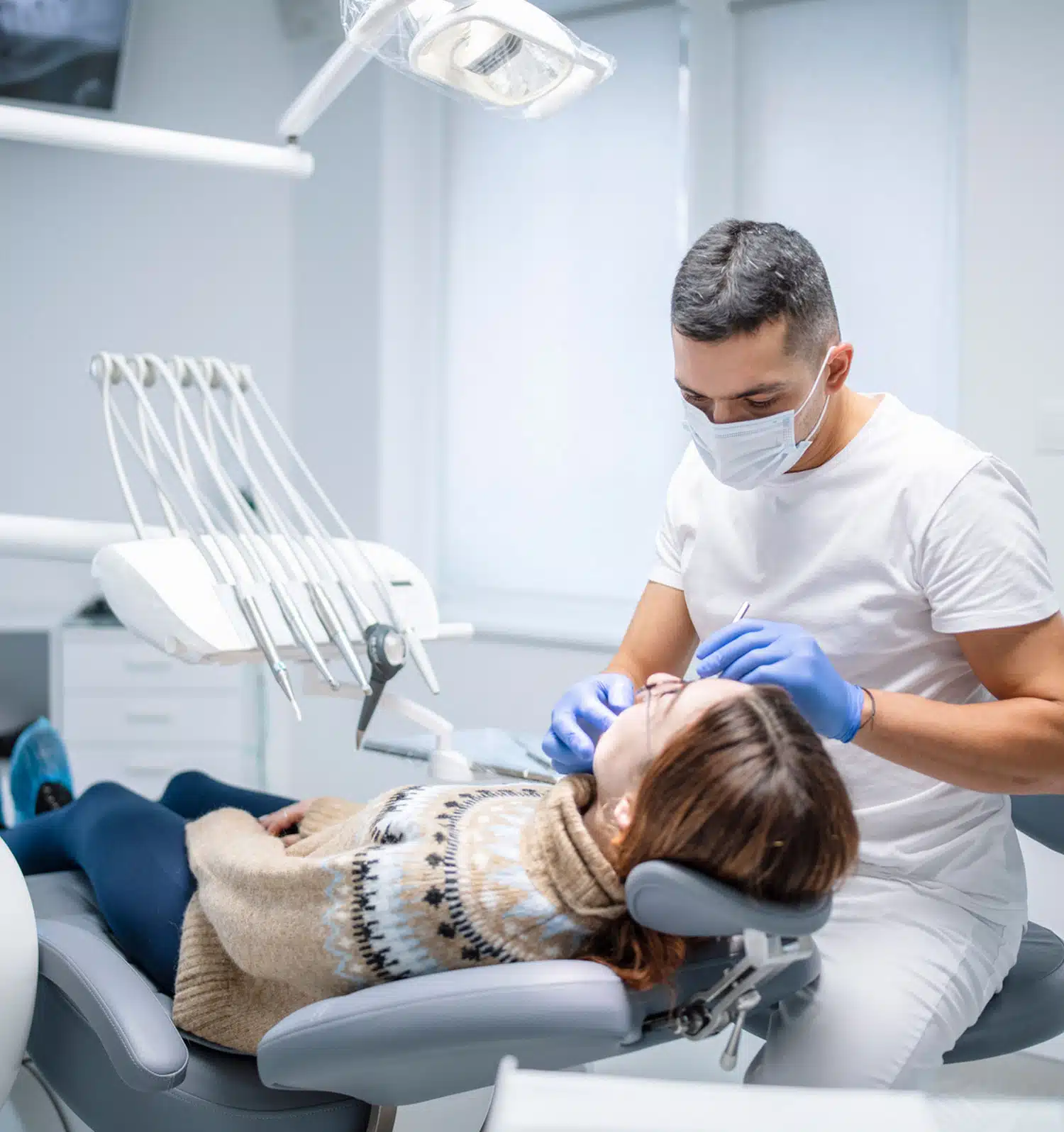Happy patient receiving professional teeth treatment at a dentist's office
