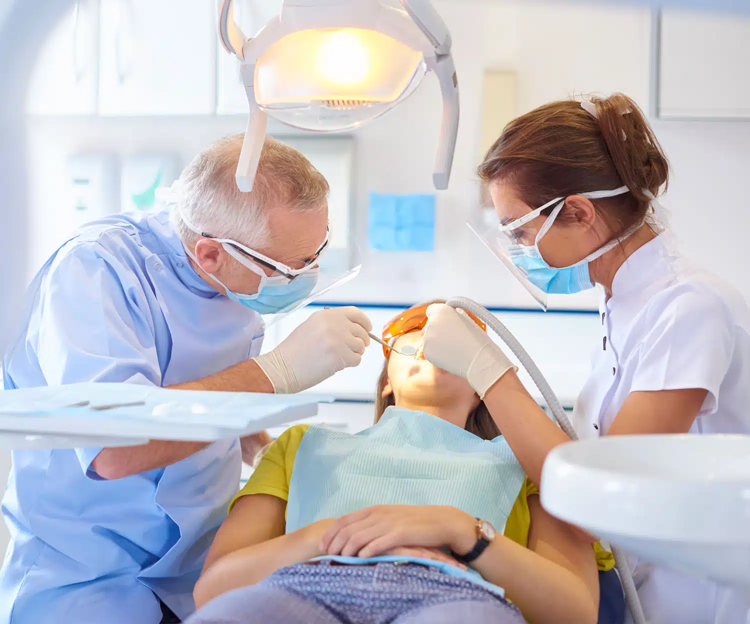 Two dentists doing procedure in a patient