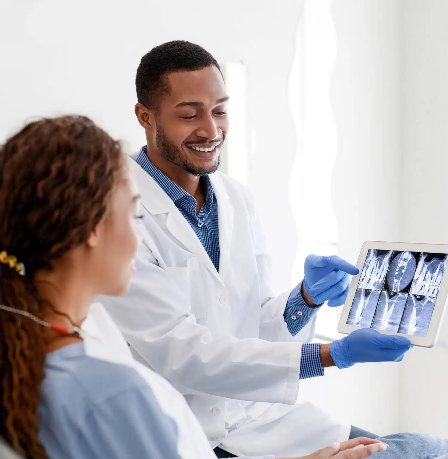 Dentist explaining the Oral Screening to a female patient
