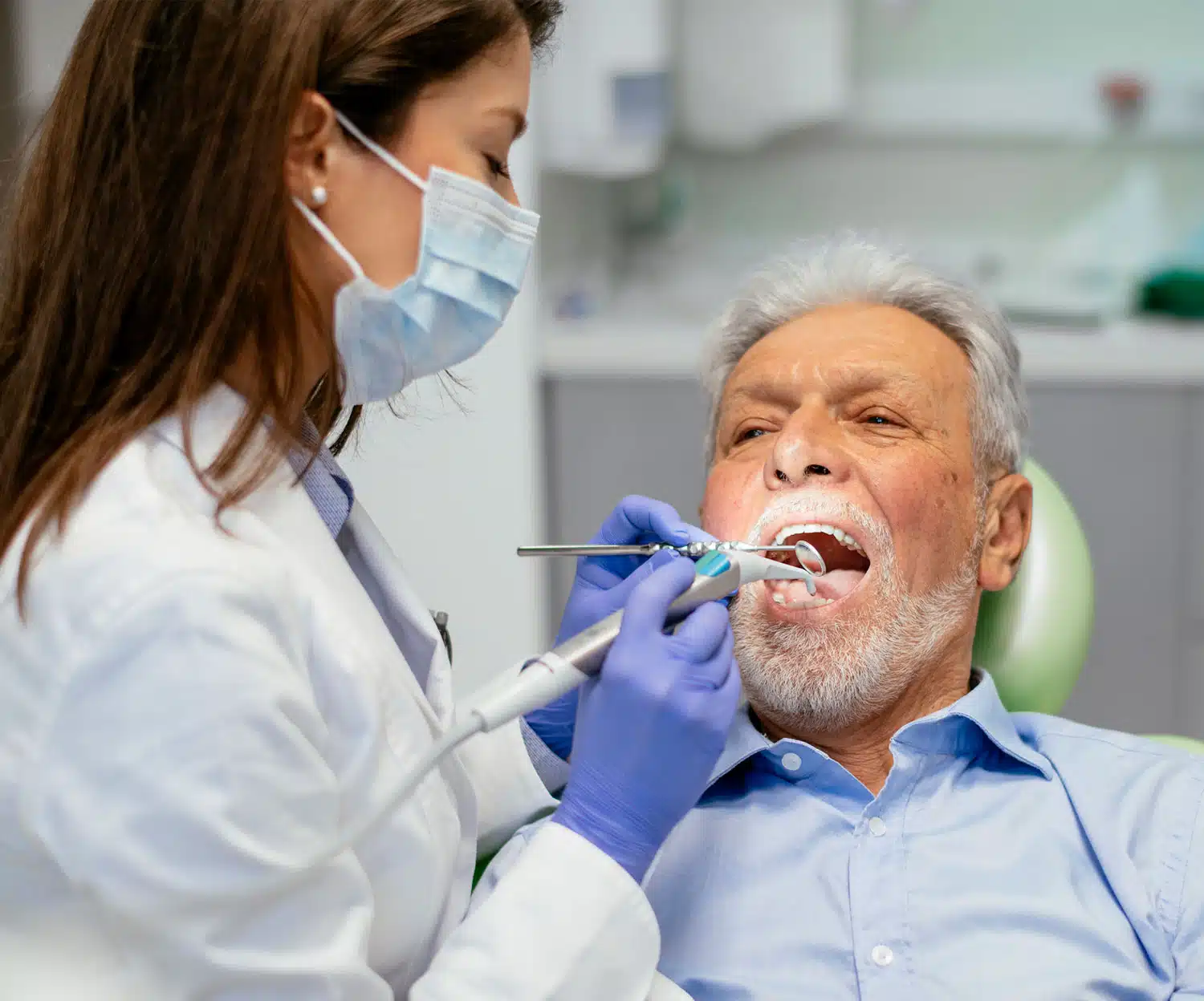 men doing Teeth Cleaning with a dentist
