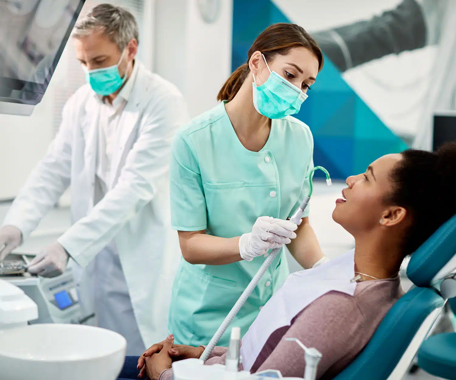 Dentist and assistant getting patient ready for a procedure