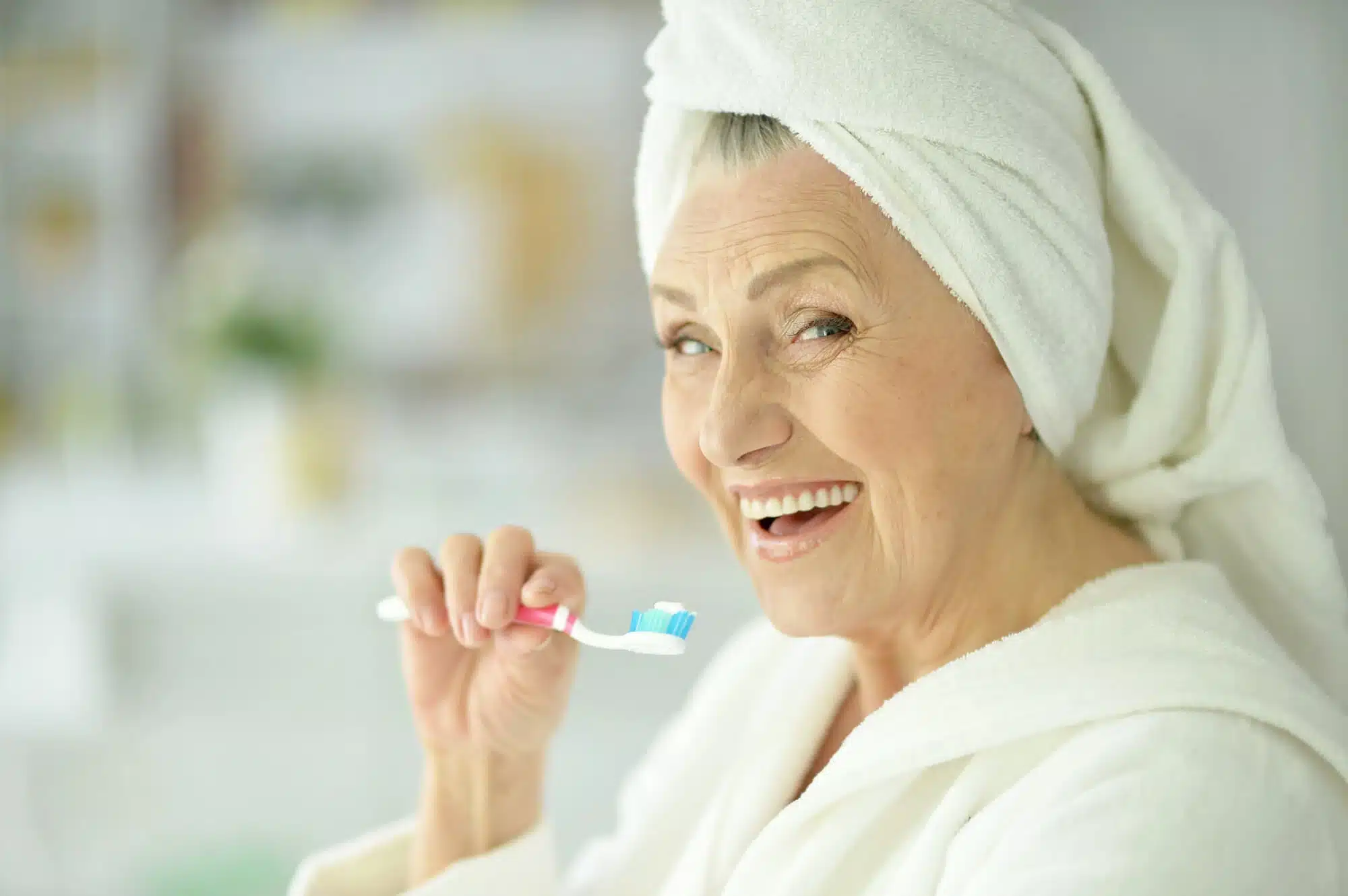 senior brushing teeth before seeing a Novi Family Dentist