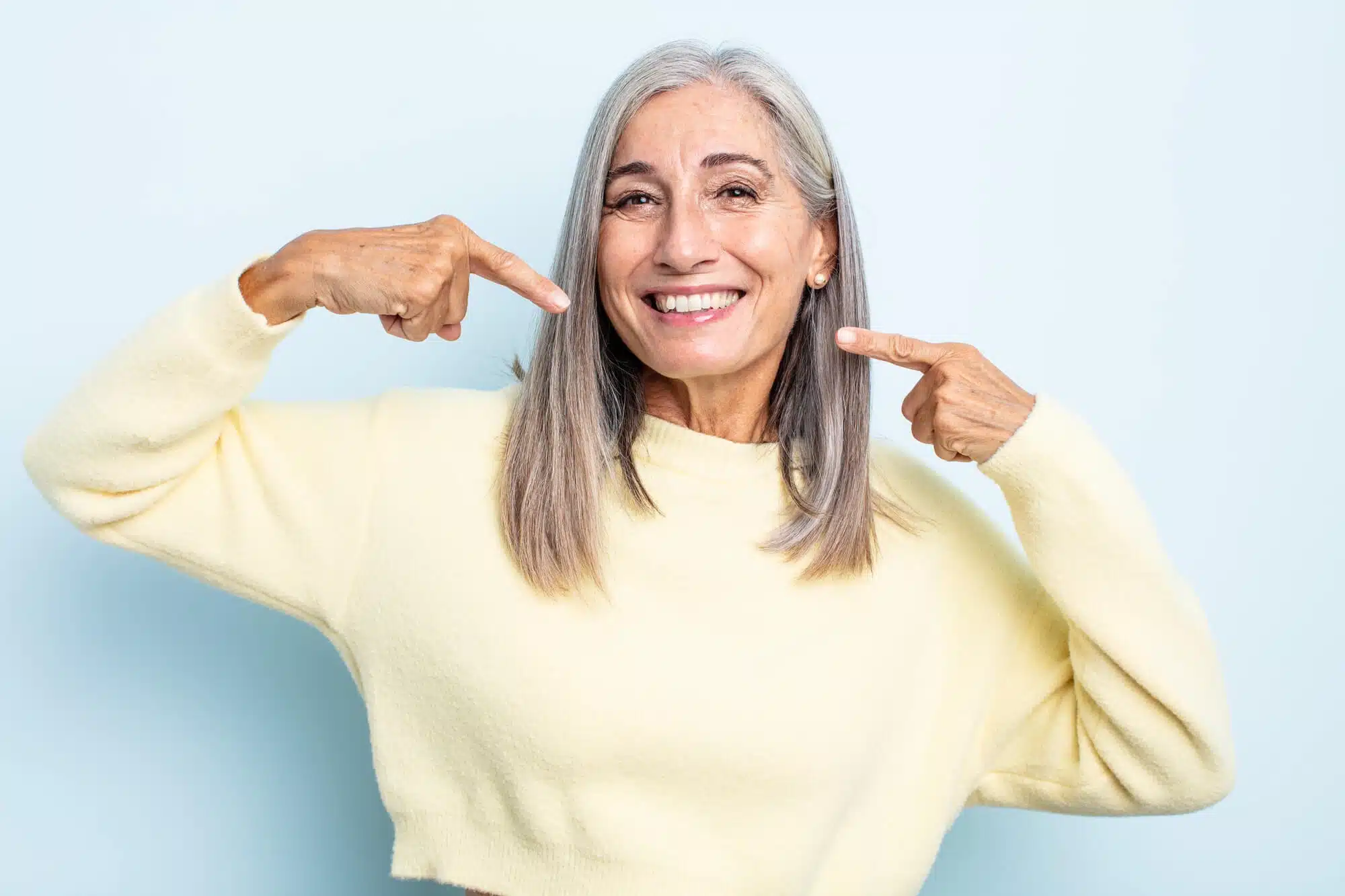senior smiling after seeing a Novi Family Dentist