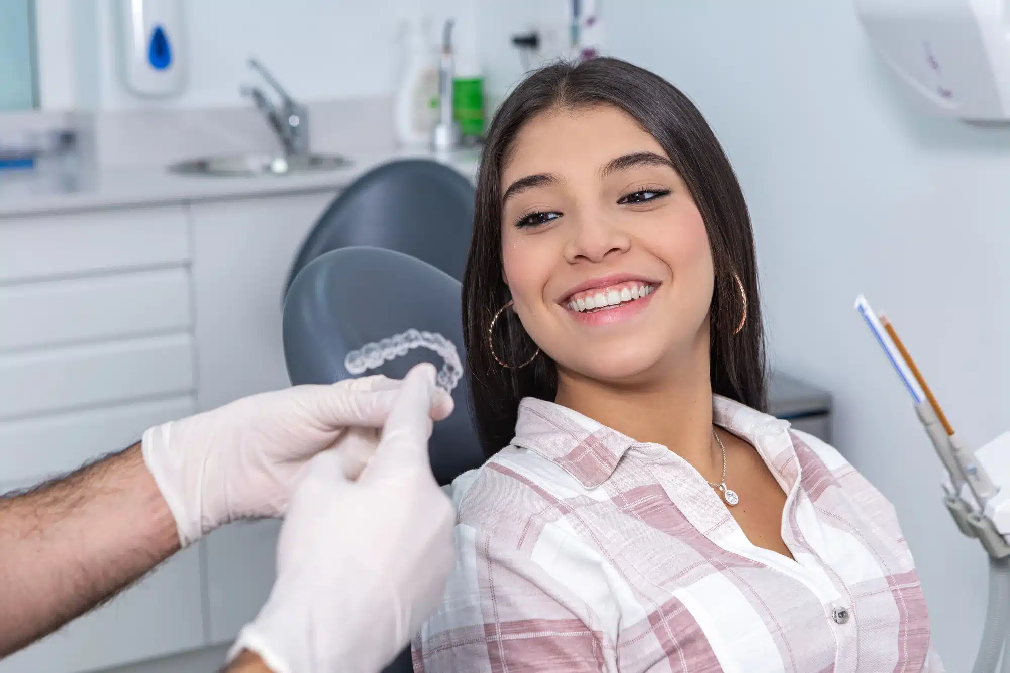 patient trying on clear aligners with orthodontist in Novi, MI