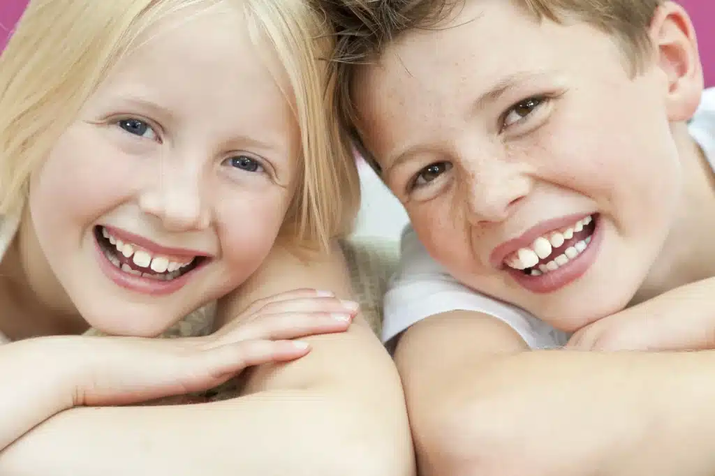 happy brother and sister after the Novi family dentist